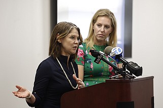Kristi Putnam (left), secretary of the Arkansas Department of Human Services, speaks as Melissa Weatherton (right), director of Specialty Medicaid Services, looks on during a news conference in Little Rock on Friday, May 3, 2024. Arkansas officials were announcing four new pilot programs designed to better serve children with behavior issues or who are experiencing a major transition. They also announced the availability of $20 million in grants meant to fill gaps in services for people with mental illness, substance abuse disorders or developmental or intellectual disabilities. (Arkansas Democrat-Gazette/Thomas Metthe)